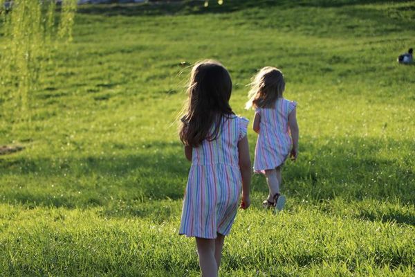 Girls running through the field